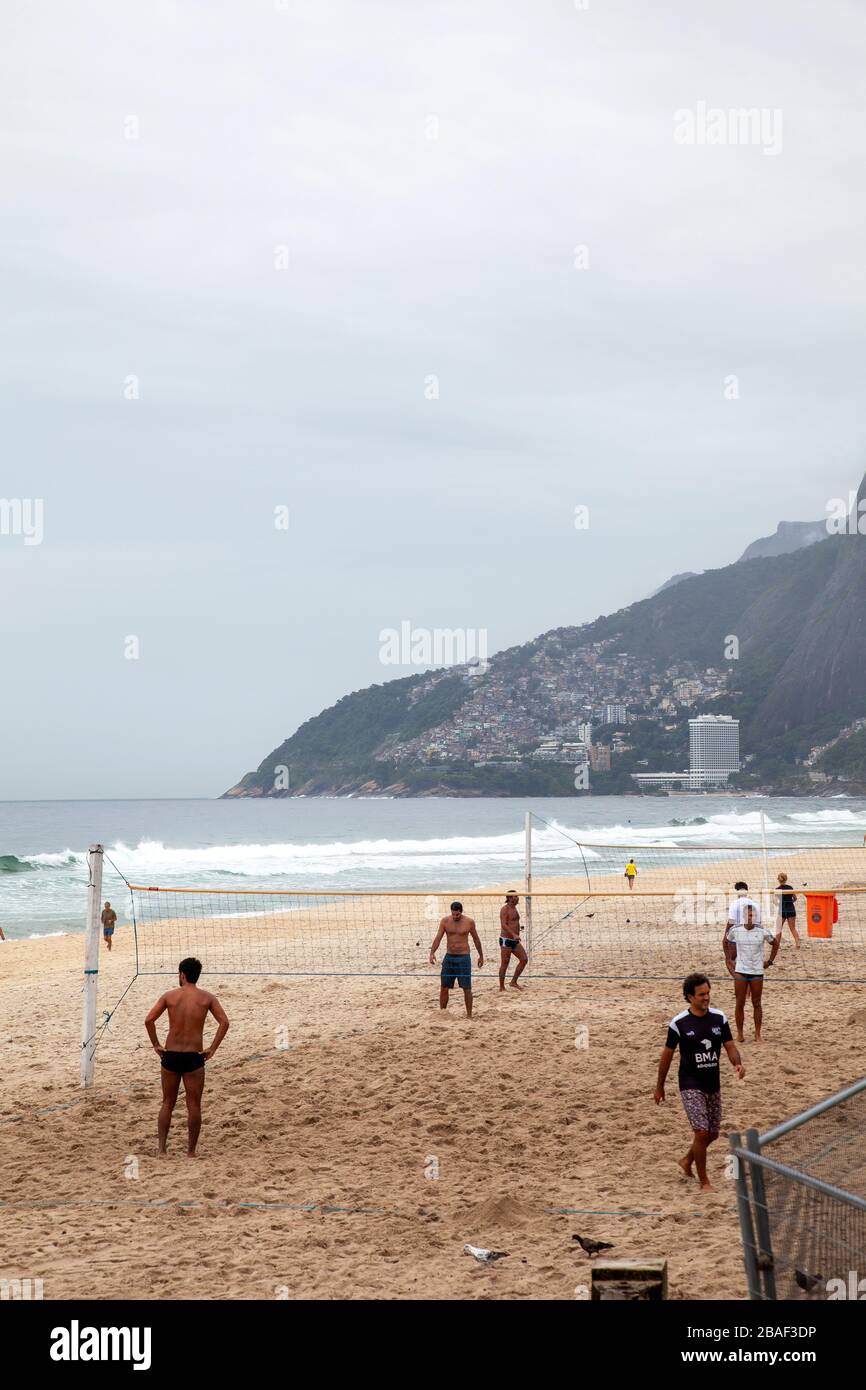 Men Playing Volleyball on Overcast Morning on Ipanema Beach - Rio, Brazil Stock Photo