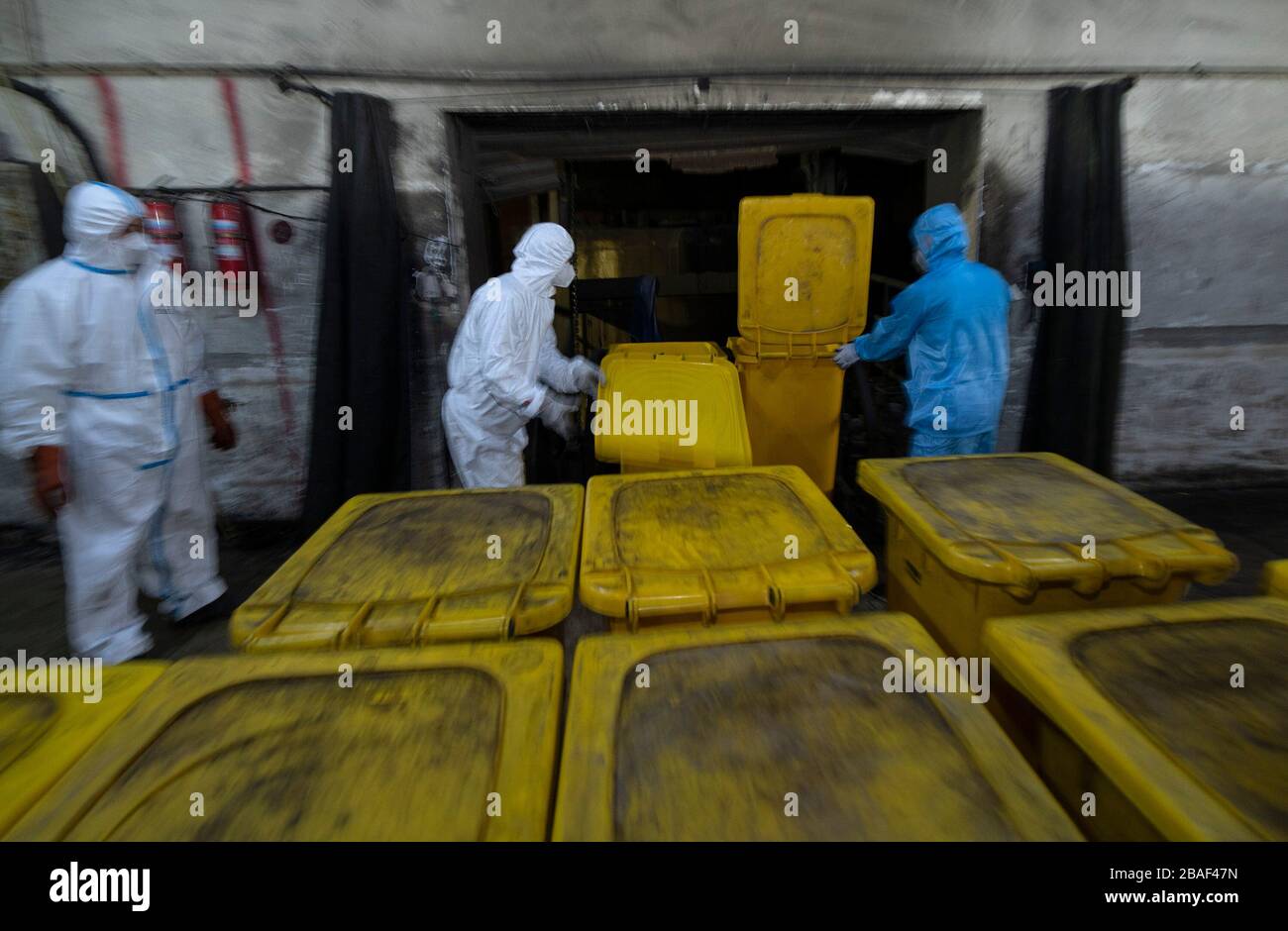 (200327) -- WUHAN, March 27, 2020 (Xinhua) -- Wang Peng (C) and his colleagues work at a medical waste treatment company in Wuhan, central China's Hubei Province, March 26, 2020. Wang Peng, 35, has been working for the Wuhan Hanshi Environmental Engineering Company for 9 years, where he is responsible for the disposal and incineration of medical waste.Protection against infection is a major challenge that Wang and his coworkers face, as they work 12-hour shifts to cope with the surging workload during the COVID-19 outbreak. 'I like what I'm doing,' Wang said, 'I'm not only making money for my Stock Photo