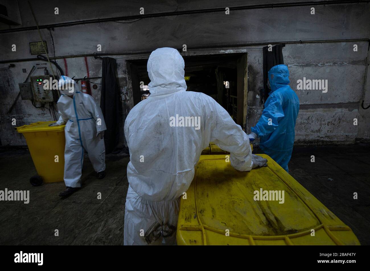 (200327) -- WUHAN, March 27, 2020 (Xinhua) -- Wang Peng (C) and his colleagues work at a medical waste treatment company in Wuhan, central China's Hubei Province, March 26, 2020. Wang Peng, 35, has been working for the Wuhan Hanshi Environmental Engineering Company for 9 years, where he is responsible for the disposal and incineration of medical waste.Protection against infection is a major challenge that Wang and his coworkers face, as they work 12-hour shifts to cope with the surging workload during the COVID-19 outbreak. 'I like what I'm doing,' Wang said, 'I'm not only making money for my Stock Photo