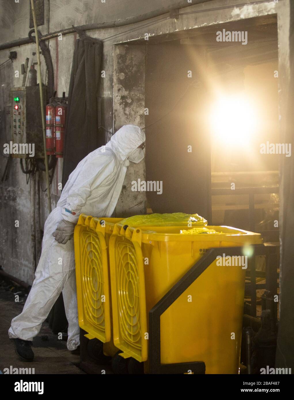 (200327) -- WUHAN, March 27, 2020 (Xinhua) -- Wang Peng works at a medical waste treatment company in Wuhan, central China's Hubei Province, March 26, 2020. Wang Peng, 35, has been working for the Wuhan Hanshi Environmental Engineering Company for 9 years, where he is responsible for the disposal and incineration of medical waste.Protection against infection is a major challenge that Wang and his coworkers face, as they work 12-hour shifts to cope with the surging workload during the COVID-19 outbreak. 'I like what I'm doing,' Wang said, 'I'm not only making money for my family, but also makin Stock Photo