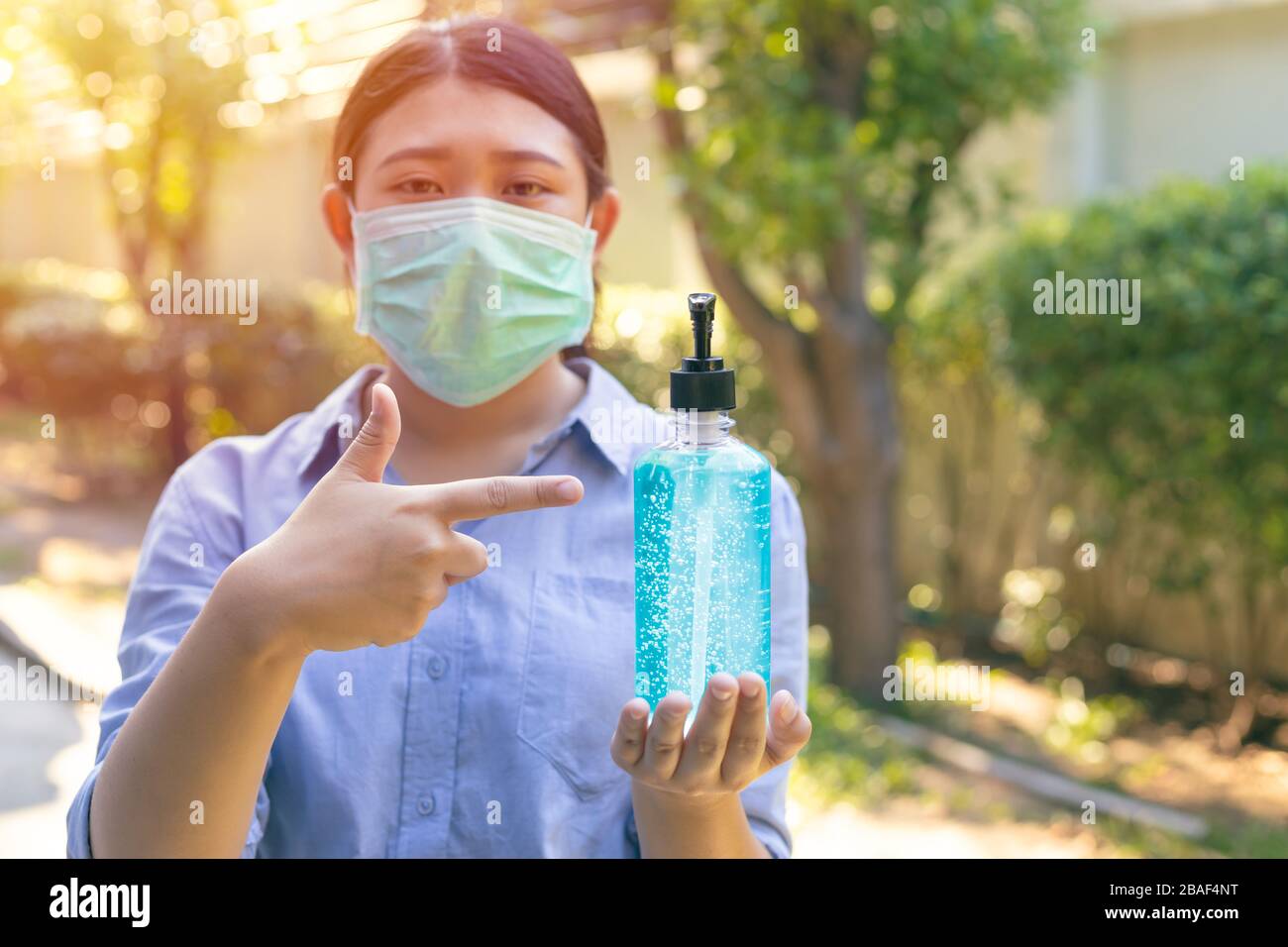 People using protection disposable face mask and alcohol hand gel for self protect from corona virus covid-19 Stock Photo