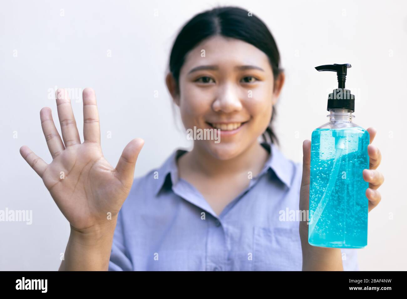 Clean hand using alcohol gel hand sanitizer cleaners for anti becteria and protect from Coronavirus Disease 2019 (COVID-19) virus outbreaks. Stock Photo