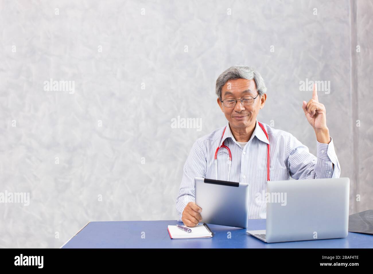 Chinese doctor using computer tablet with figured out thinking find a solution to anti virus found something and creativity action. Stock Photo