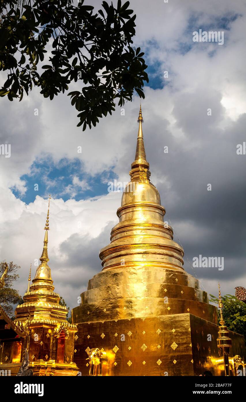 Wat Phra Sing with golden Stupa at cloudy sky background in, Chiang Mai, Thailand Stock Photo