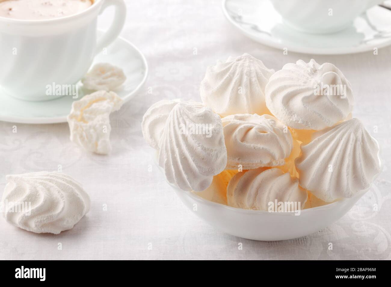 Tender, airy Bizet and a cup of fresh coffee with cream Stock Photo