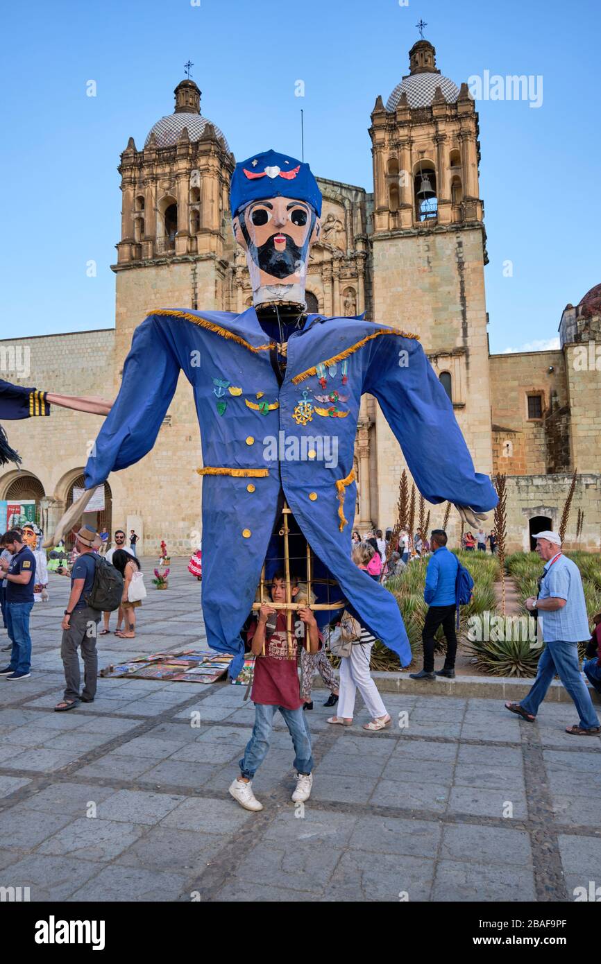 Giant puppet dressed as a decorated sailor dancing in front of Santo Domingo church. Oaxaca, Mexico. Stock Photo