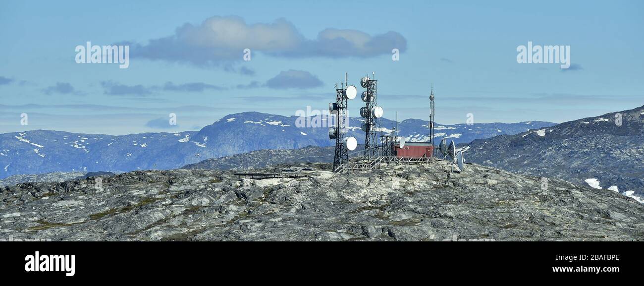 Telecommunication tower Antenna. View from a nearby hill, overlooking the town of Illulisat, West Greenland . Stock Photo