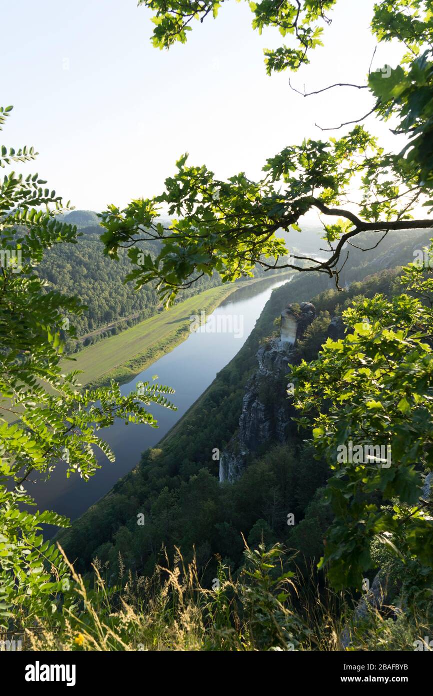 View of the German Elbe River near the Bastei in the afternoon in summer, Elbe Sandstone Mountains, Saxon Switzerland National Park, State of Saxony, Stock Photo
