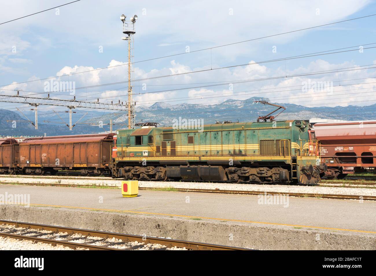 Freight train with MACOSA Diesel-electric locomotive 644 at the rail station, Podgorica, Montenegro, Europe Stock Photo