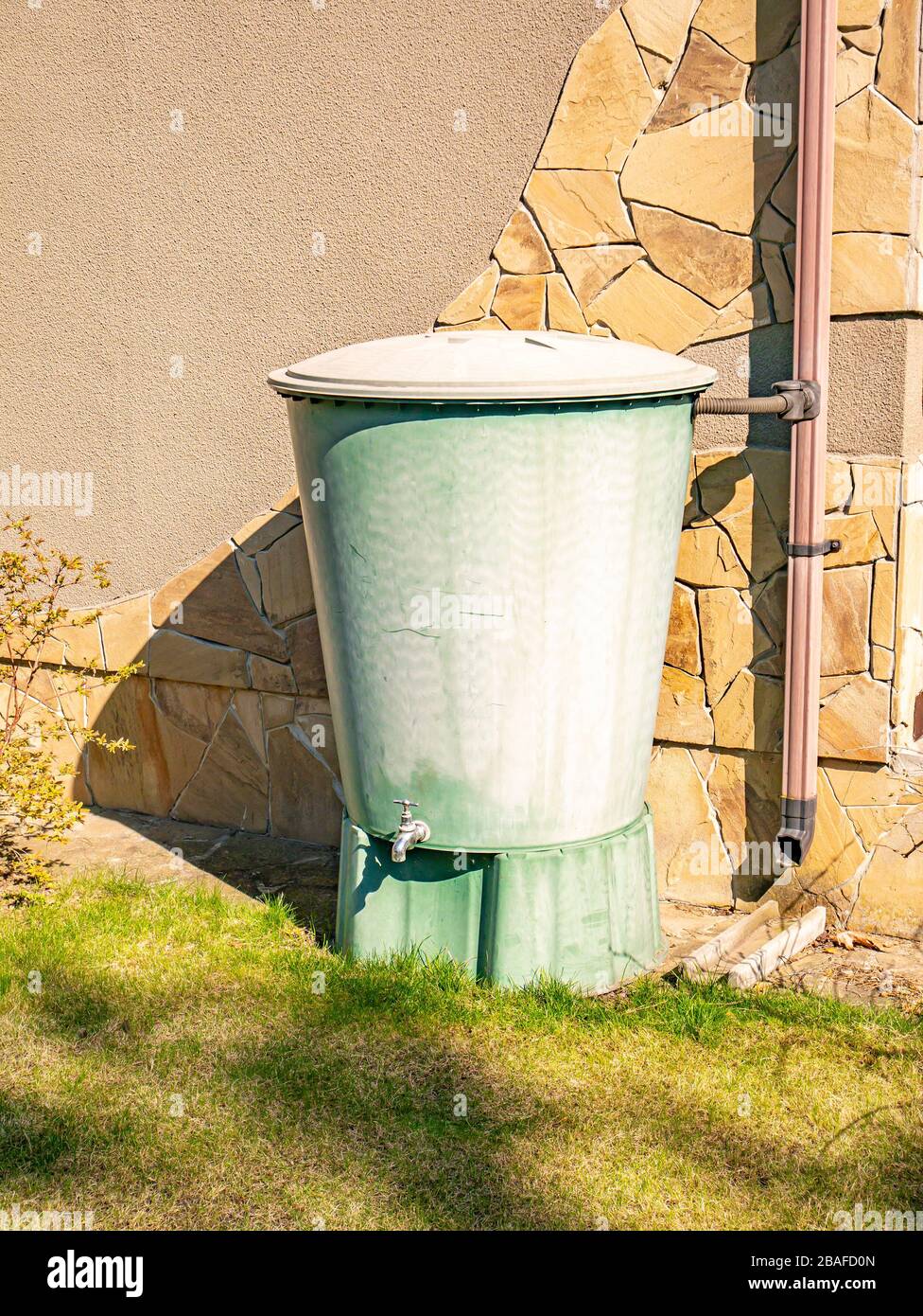 Large plastic water tank with tap in the garden Stock Photo Alamy