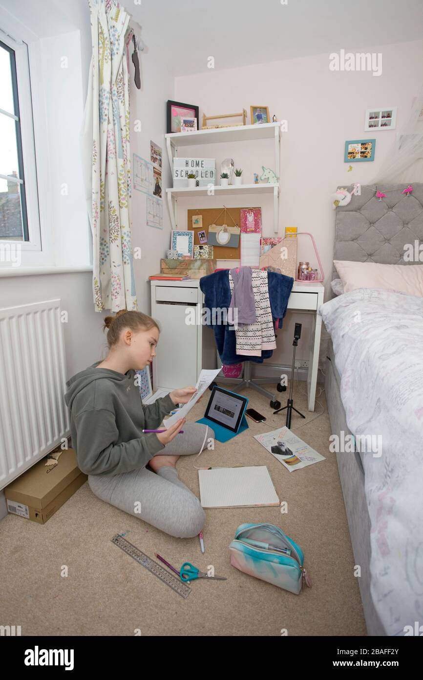 Young girl doing school work at home during Coronavirus pandemic, England Stock Photo