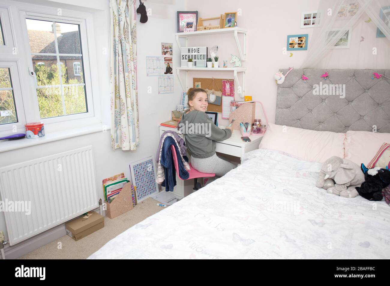 Young girl doing school work from home during coronavirus pandemic, England Stock Photo