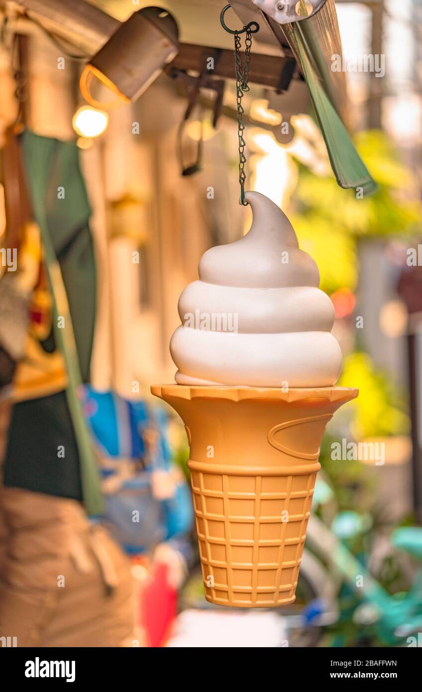 https://c8.alamy.com/comp/2BAFFWN/large-plastic-vanilla-ice-cream-cone-hanging-on-the-front-of-a-store-2BAFFWN.jpg