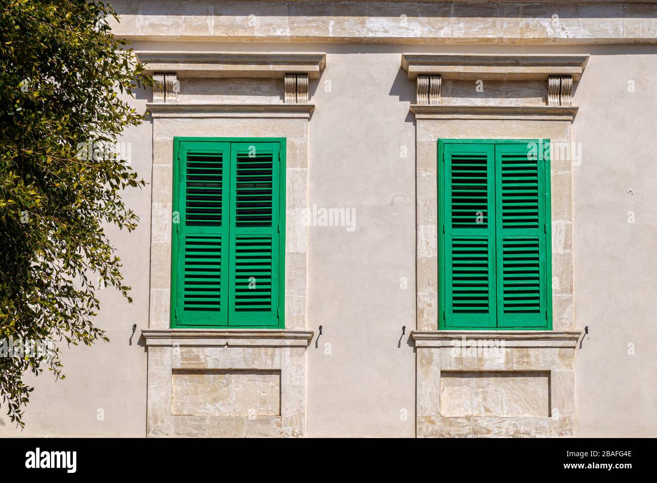 windows in the facades of ancient medieval houses Stock Photo