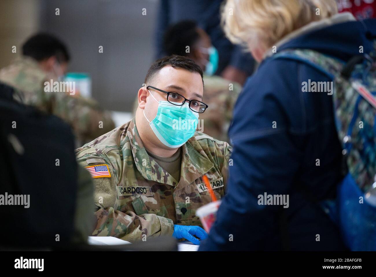 Providence, United States. 27th Mar, 2020. Members of the Rhode Island Army National Guard record information from arriving travelers inside Providence Train Station in Providence, Rhode Island on Thursday, March 27, 2020. The National Guard has been brought in to take down information of travelers coming into the state as part of public health tracking for COVID-19. Rhode Island Governor Gina Raimondo also announced that all visitors arriving from New York to the state will be required to self quarantine for 14 days. Photo by Matthew Healey/UPI Credit: UPI/Alamy Live News Stock Photo