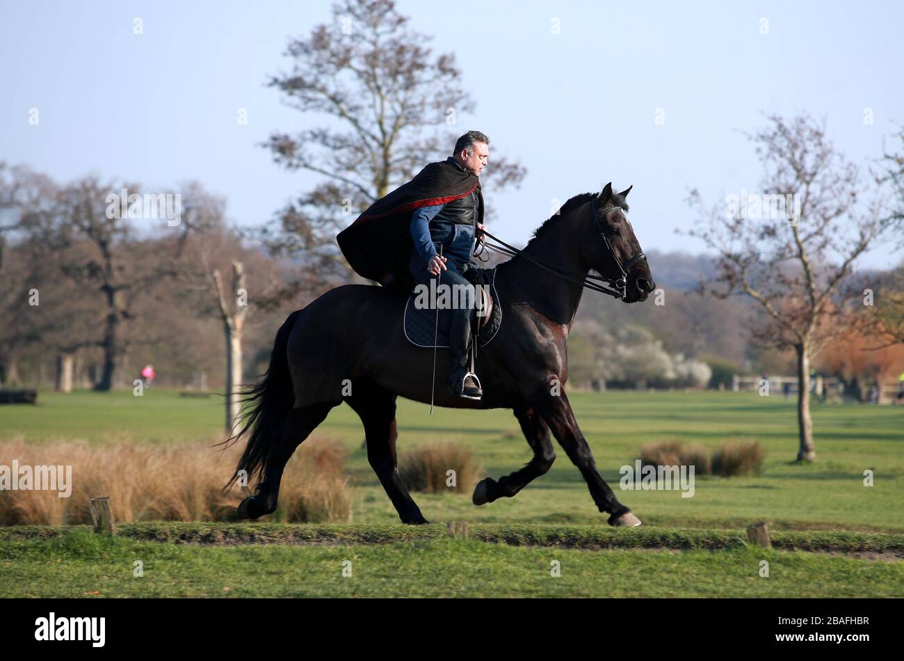 A person riding a horse in Richmond Park as the UK continues lockdown to help curb the spread of the coronavirus. Stock Photo