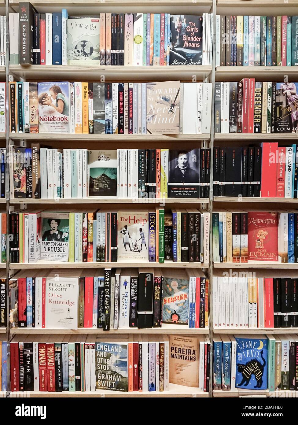 Book shop. Full frame image of classic and modern fiction paperback books and novels on the shelves of a book store. Stock Photo