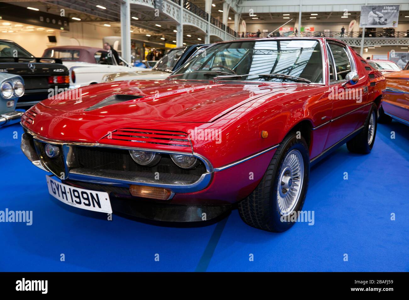 Three-quarters front view of a Red, 1974, Alfa Romeo Montreal, on display at the Coys Auction Area of the 2020 London Classic Car Show Stock Photo
