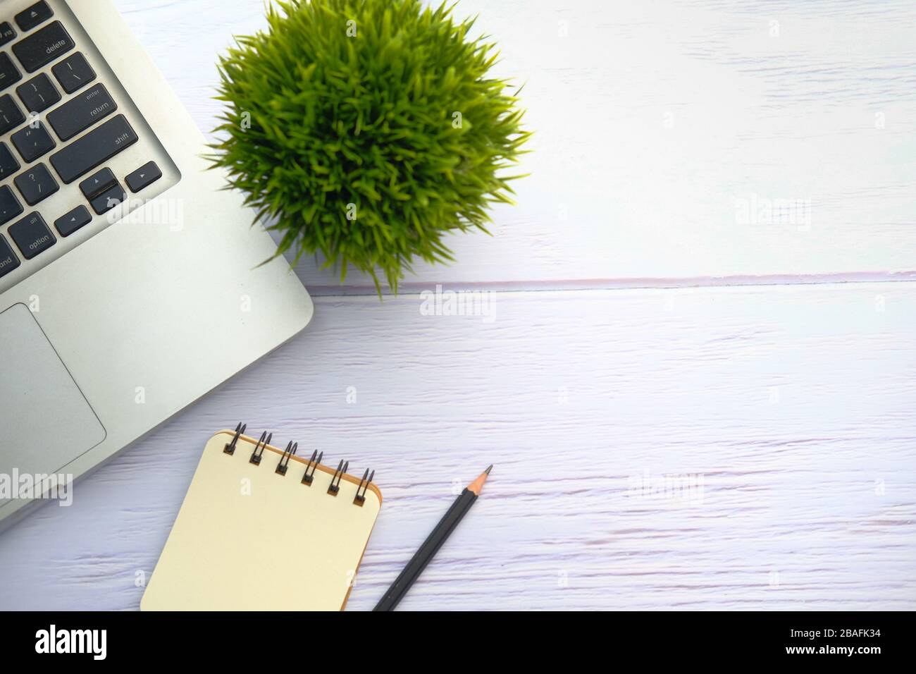 top view of laptop, notepad and pen on table with copy space. Stock Photo