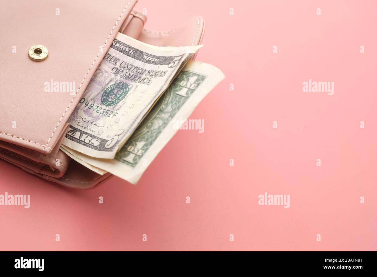 Pink wallet and Us dollar banknotes on pink background Stock Photo Alamy