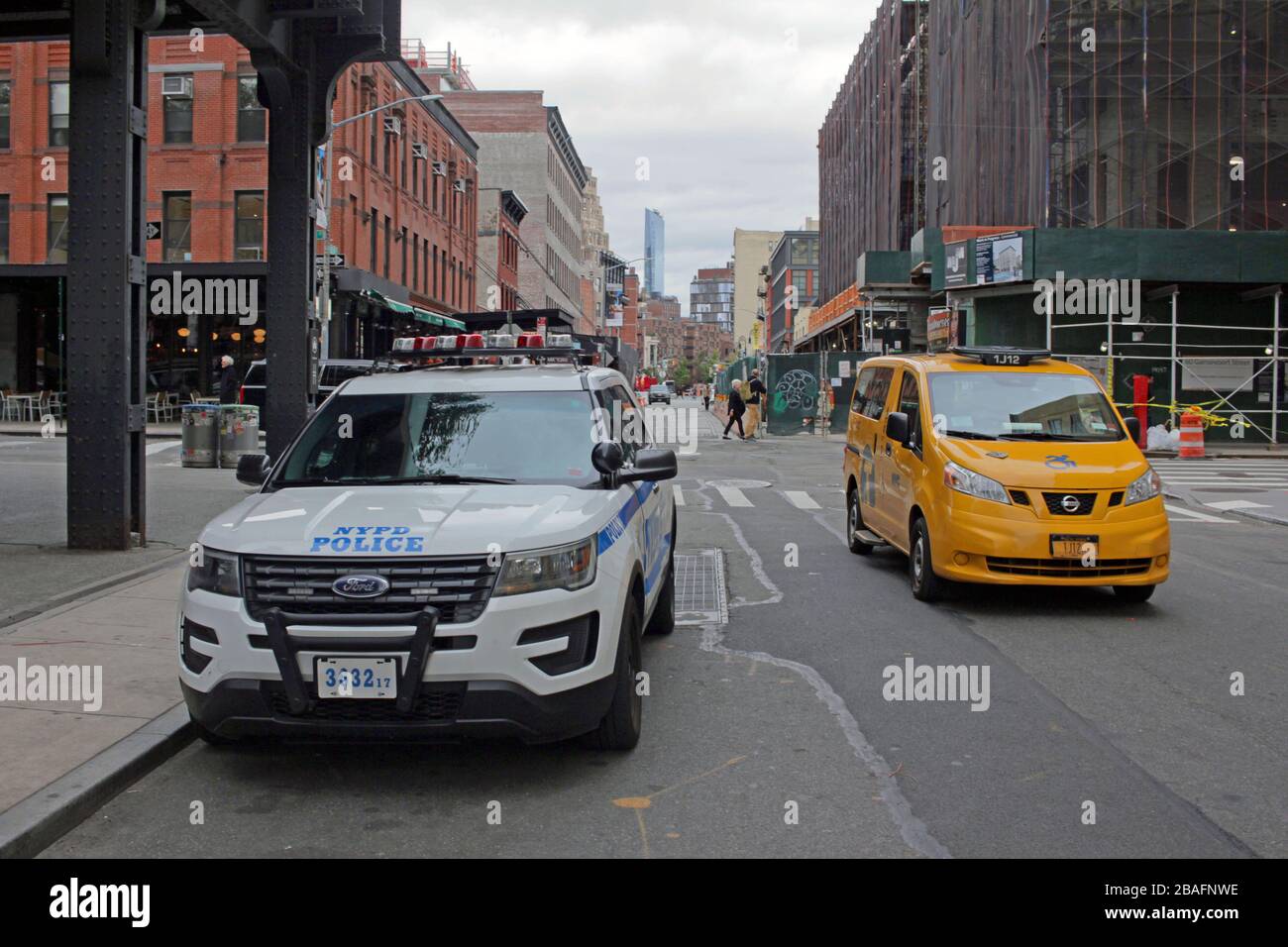 NYPD vehicle and New York Yellow Cab taxi, Meatpacking District, New York City, USA Stock Photo