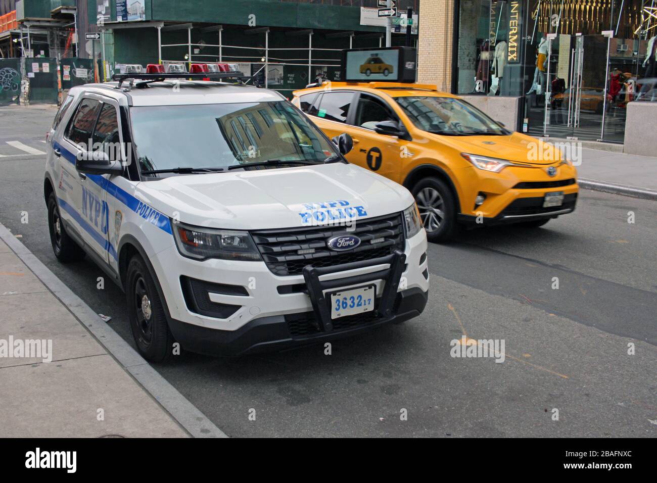 NYPD vehicle and New York Yellow Cab taxi, Meatpacking District, New York City, USA Stock Photo