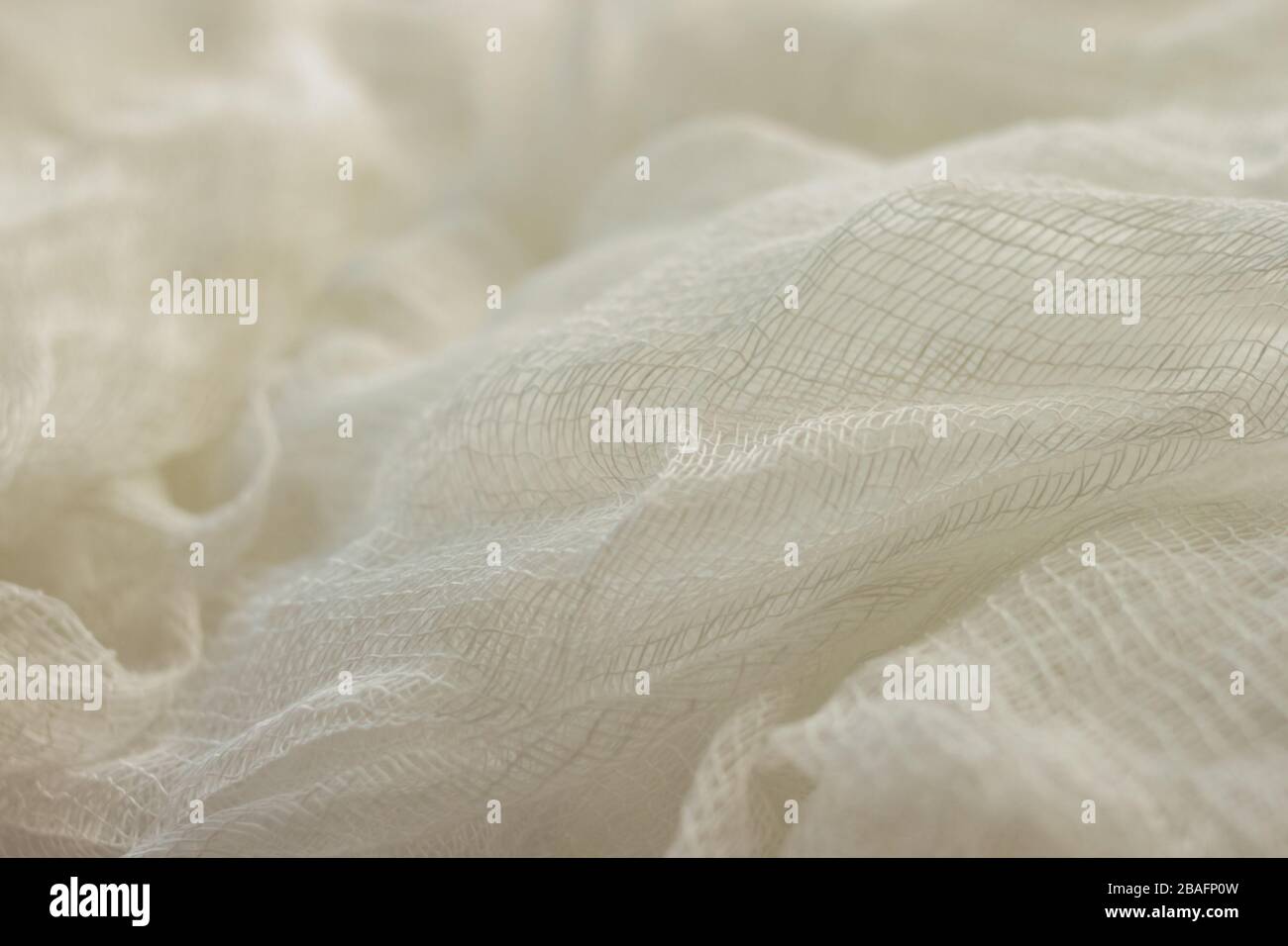 white color woven cotton gauze fabric background texture. close up top