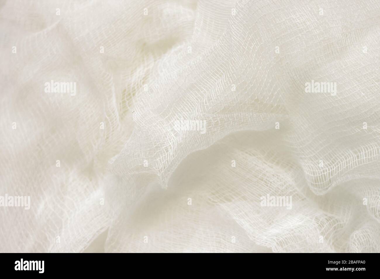 white color woven cotton gauze fabric background texture. close up top