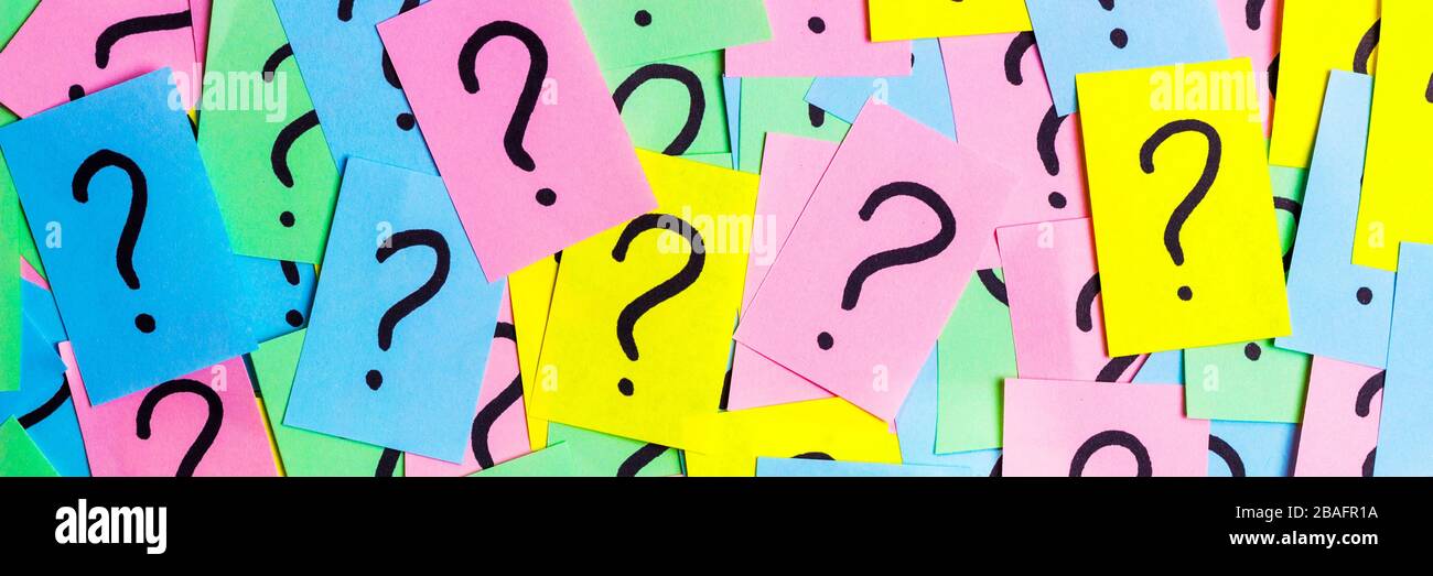 Too Many Questions. Pile of colorful paper notes with question marks. Closeup. Stock Photo