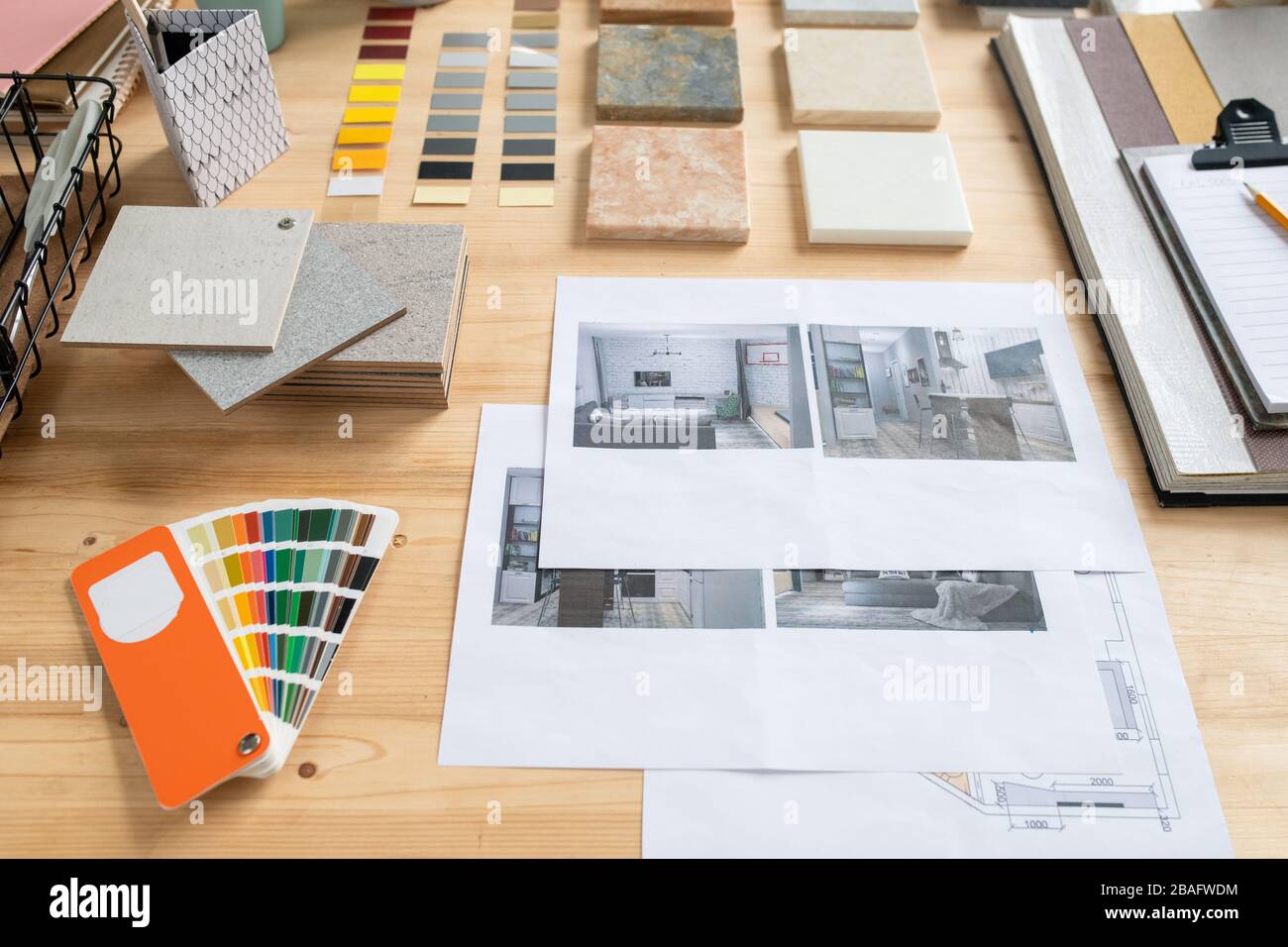 Photographs of flat or house interior, samples of panels, color swatches and palette on wooden table where creative designer works Stock Photo