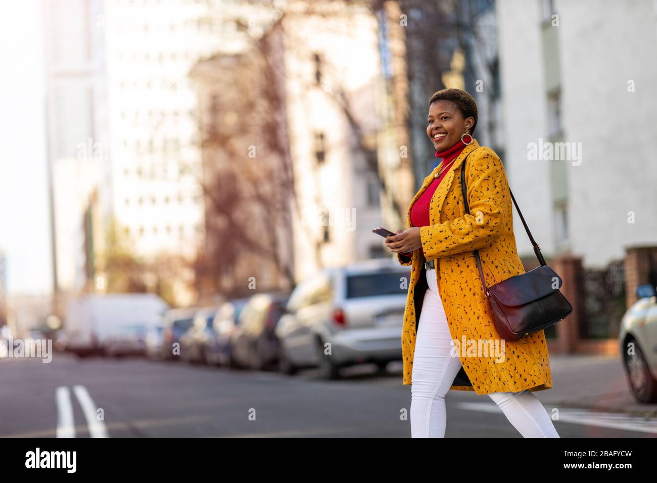 Young woman with smartphone in an urban city area Stock Photo