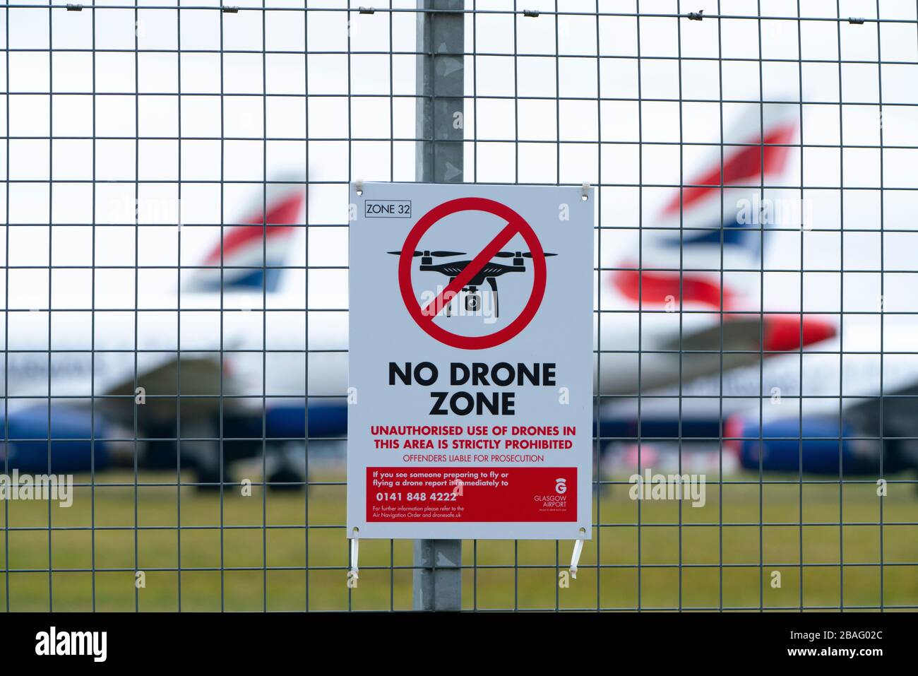 No Drone Zone warning sign on perimeter fence at Glasgow Airport, Scotland ,UK Stock Photo