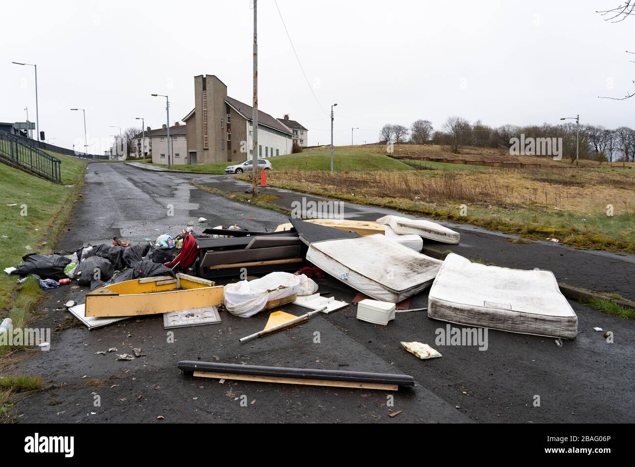 Fly tipping of household goods on street in Easterhouse in Glasgow