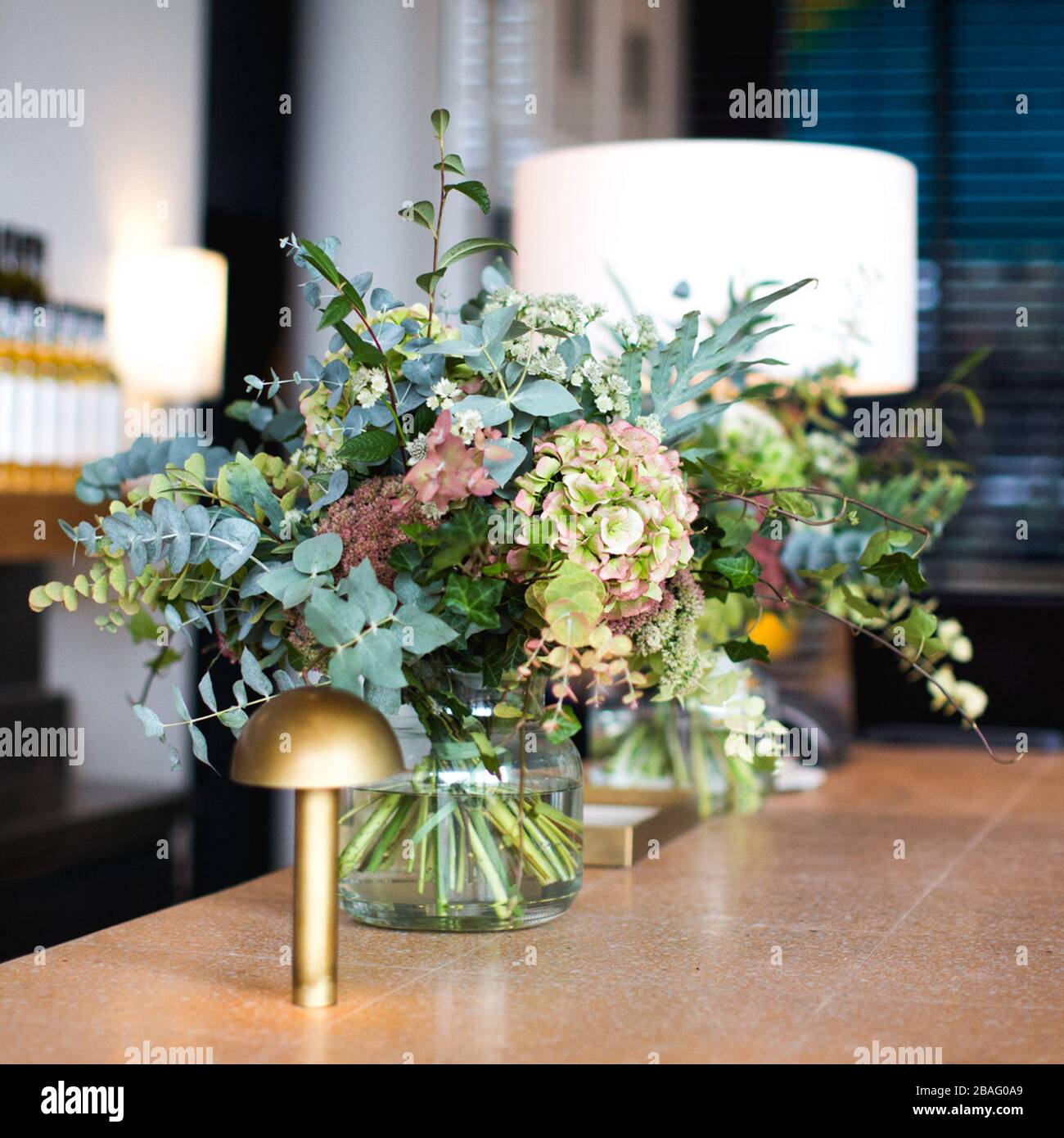 Floral table setting on the bar in a stylish modern Scandi restaurant Stock Photo