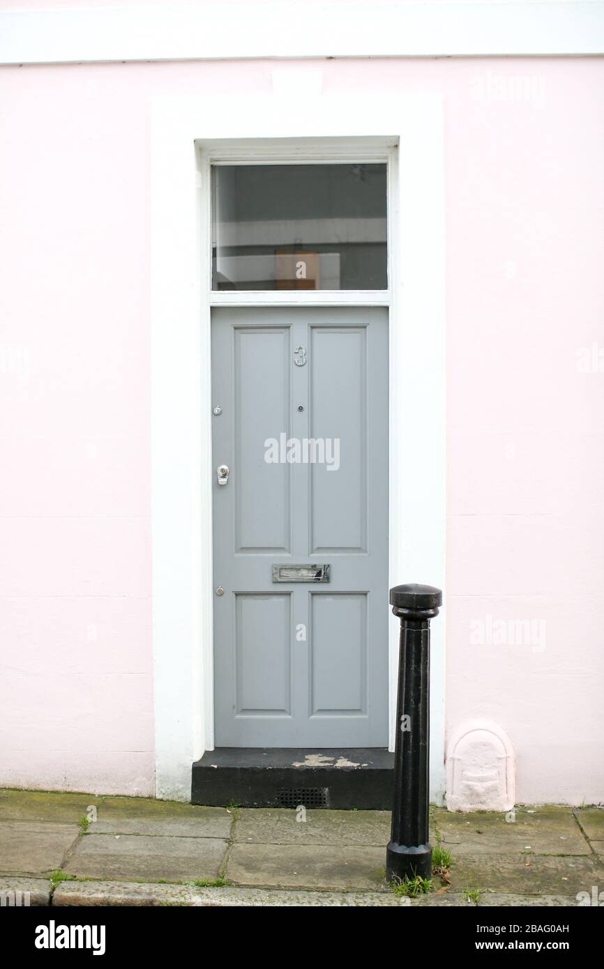 Colourful (colorful) front doors on homes/ houses in a residential urban city/ town street in Britain. Stock Photo