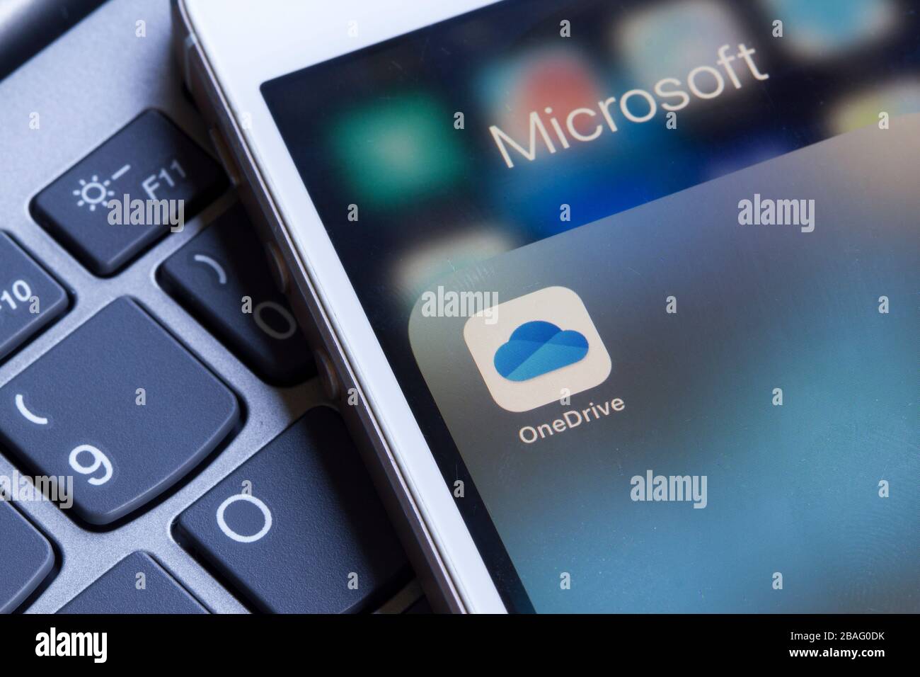 Microsoft OneDrive mobile app icon is seen on a smartphone. OneDrive is Microsoft's personal cloud storage service solution for file hosting. Stock Photo