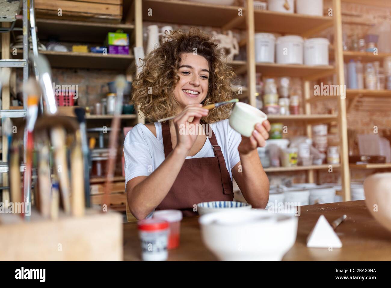 Portrait of woman pottery artist in art studio Stock Photo - Alamy
