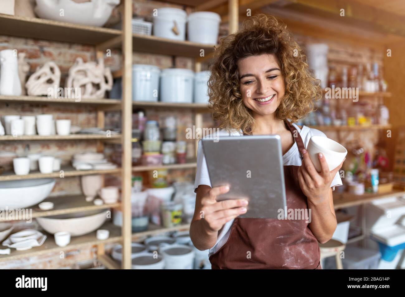 Portrait of woman pottery artist in art studio Stock Photo - Alamy