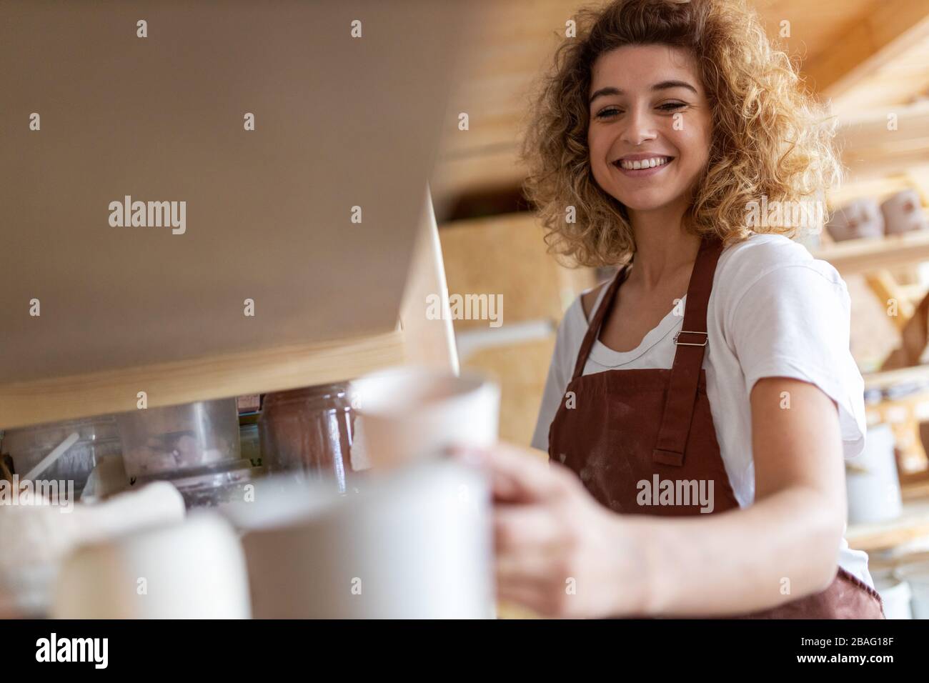 Portrait of woman pottery artist in art studio Stock Photo - Alamy