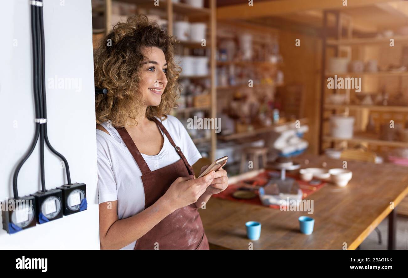 Portrait of woman pottery artist in art studio Stock Photo - Alamy