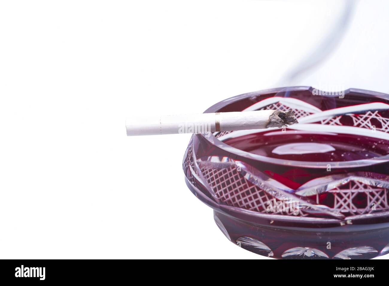 Burning cigarette on ashtray isolated over a white background Stock Photo