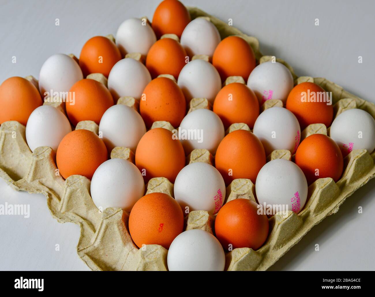 White and brown chicken eggs in a cardboard tray Stock Photo - Alamy