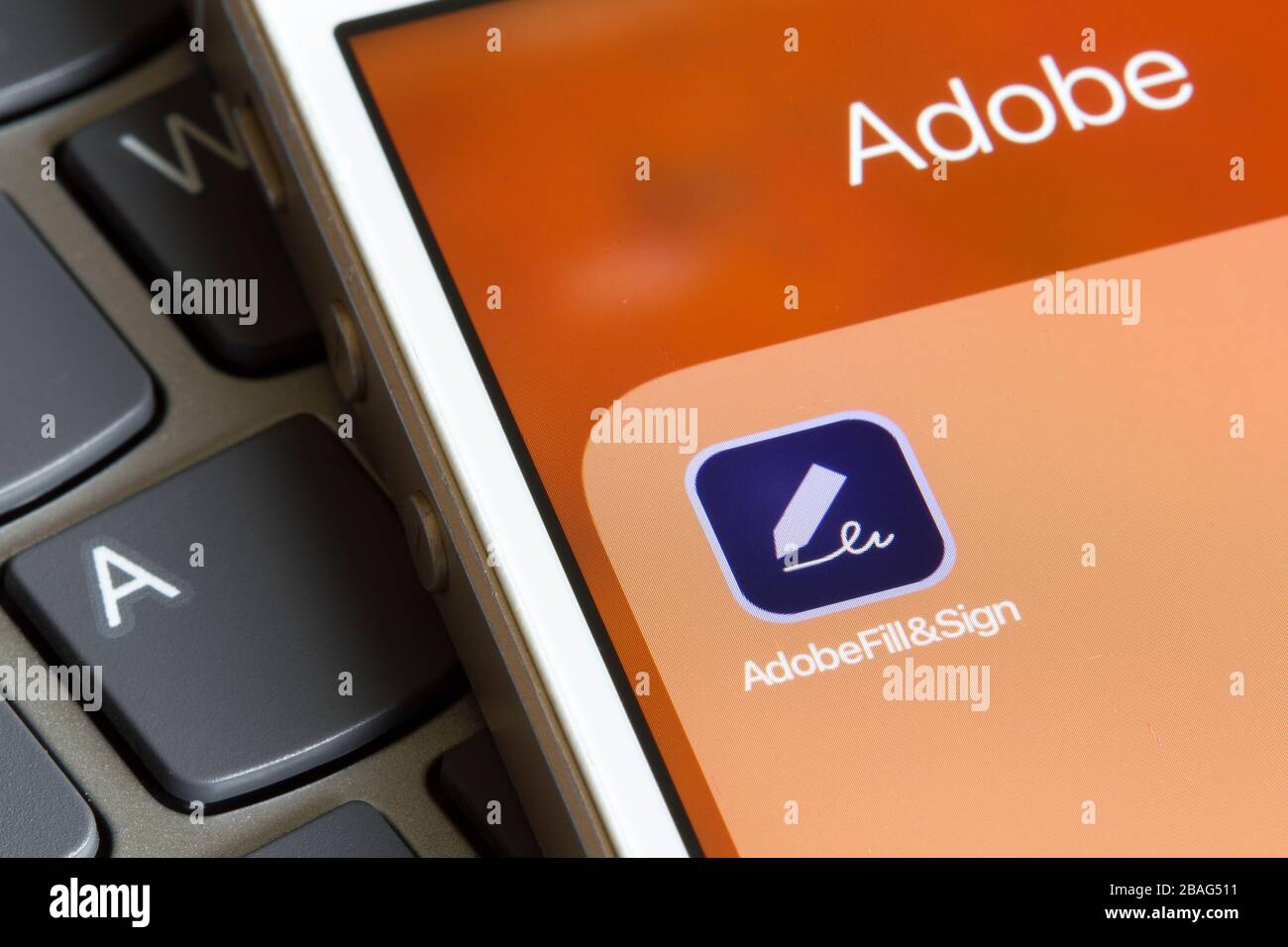 Adobe Fill and Sign mobile app icon seen on a smartphone. The application enables users to fill and sign forms anywhere from mobile devices. Stock Photo