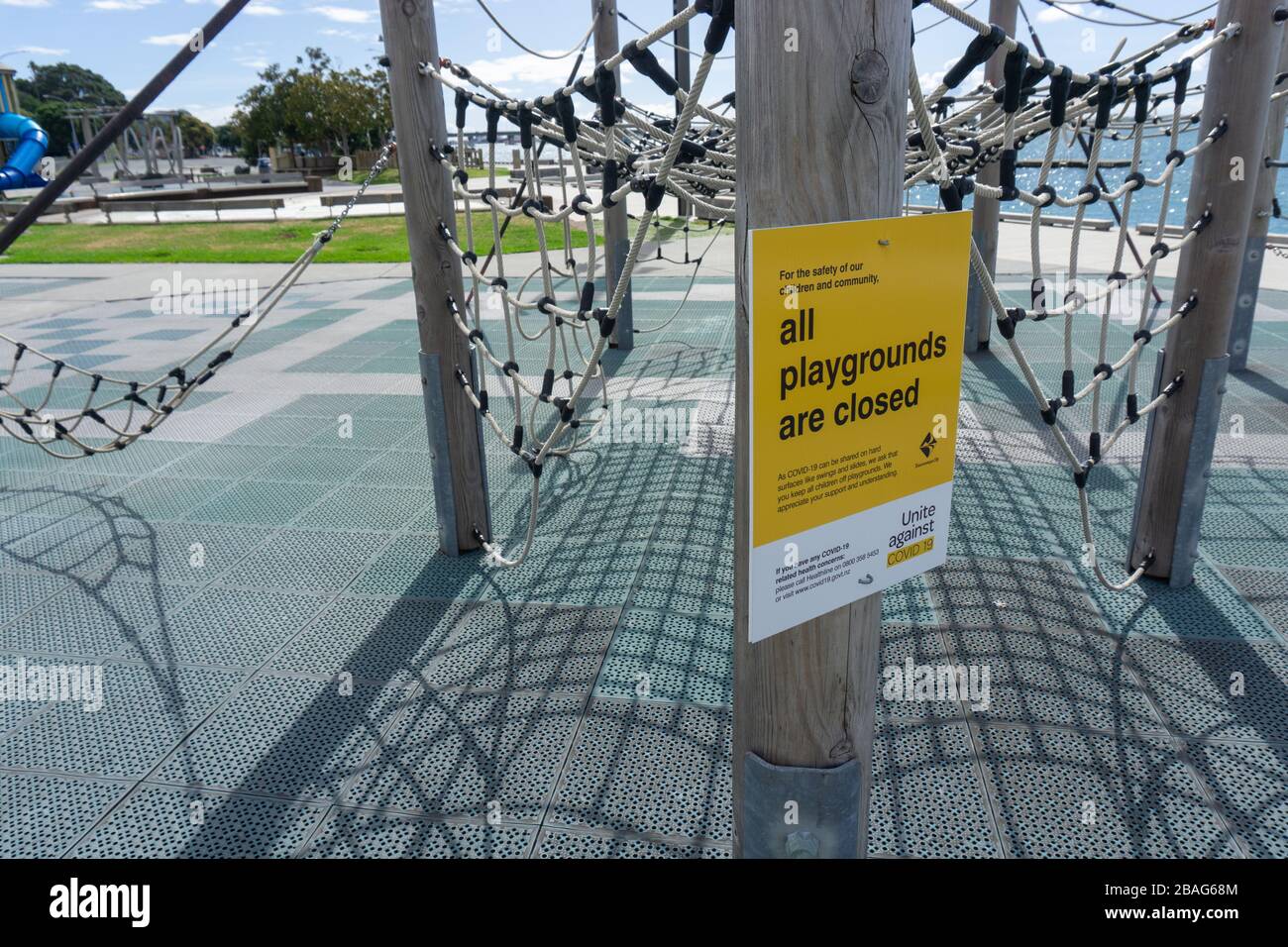 Tauranga New Zealand - March 27 2020; Eerily empty city children's playground with local council sign advising closure due to covid-19 virus lockdown. Stock Photo
