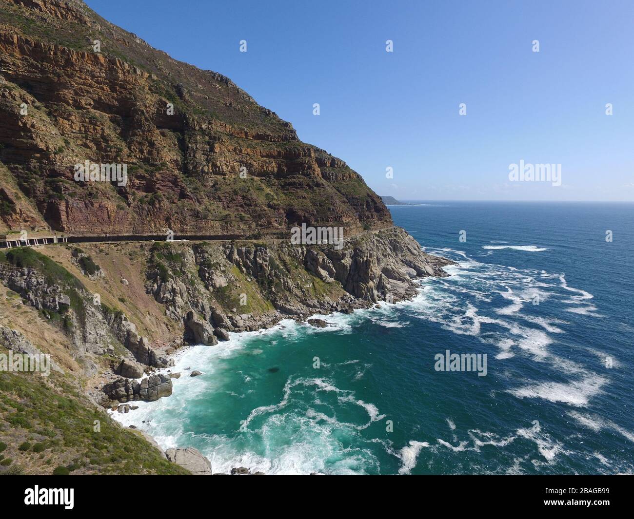 Aerial photo of Chapman's Peak with waves crashing against rocks and tunnel Stock Photo