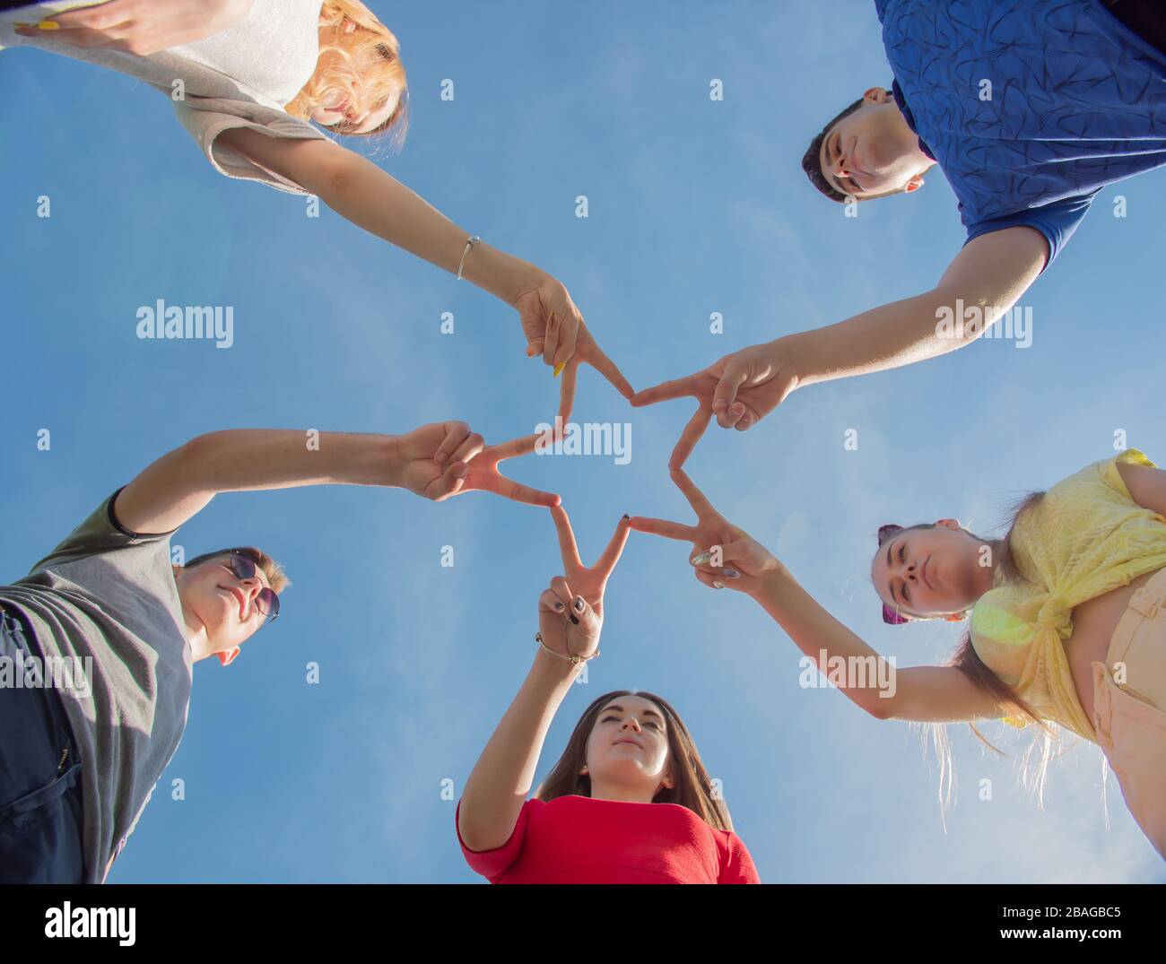 Friends make a star shape from their hands Stock Photo - Alamy