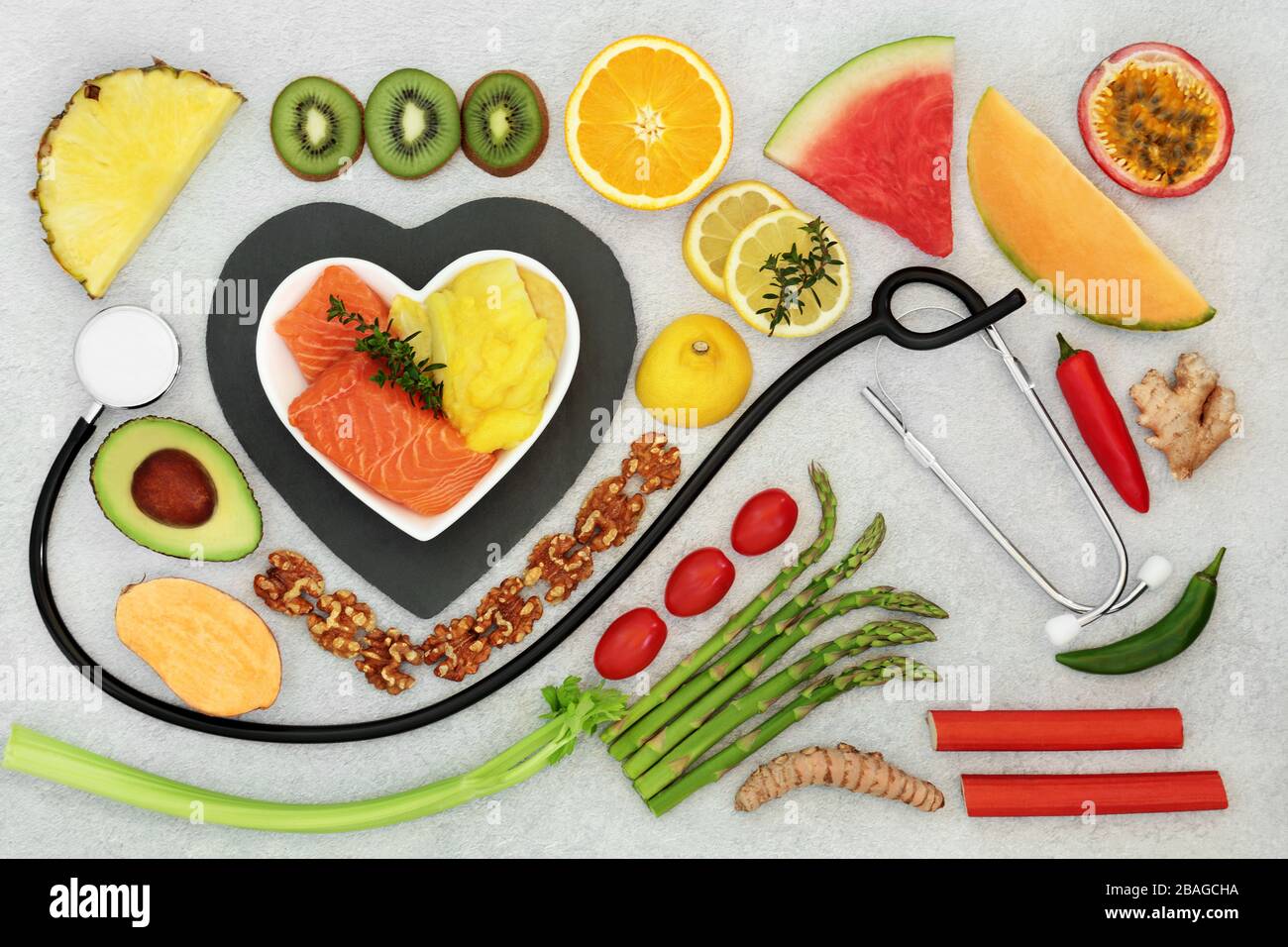 Health food for a healthy heart & cardiovascular system with stethoscope, fruit, vegetables, seafood,  herbs, spice &  nuts. Stock Photo