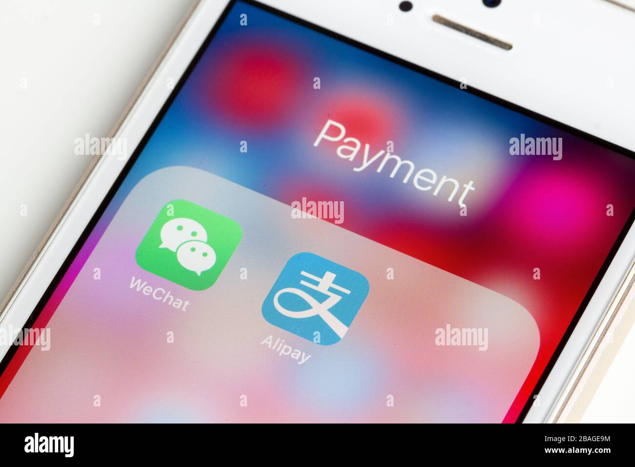 WeChat and Alipay mobile app icons are seen on a smartphone. Stock Photo