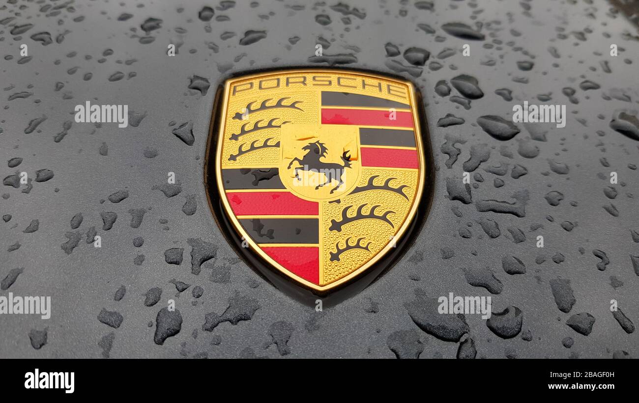 Ukraine, Kiev - March 27, 2020: Porsche logo close up on a black car with raindrops. Hood emblem of a sports car. copy space, editorial photography. G Stock Photo