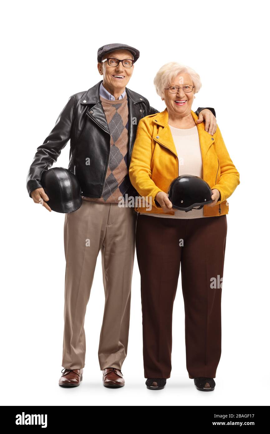 Full length portrait of a senior couple standing and holding helmets isolated on white background Stock Photo